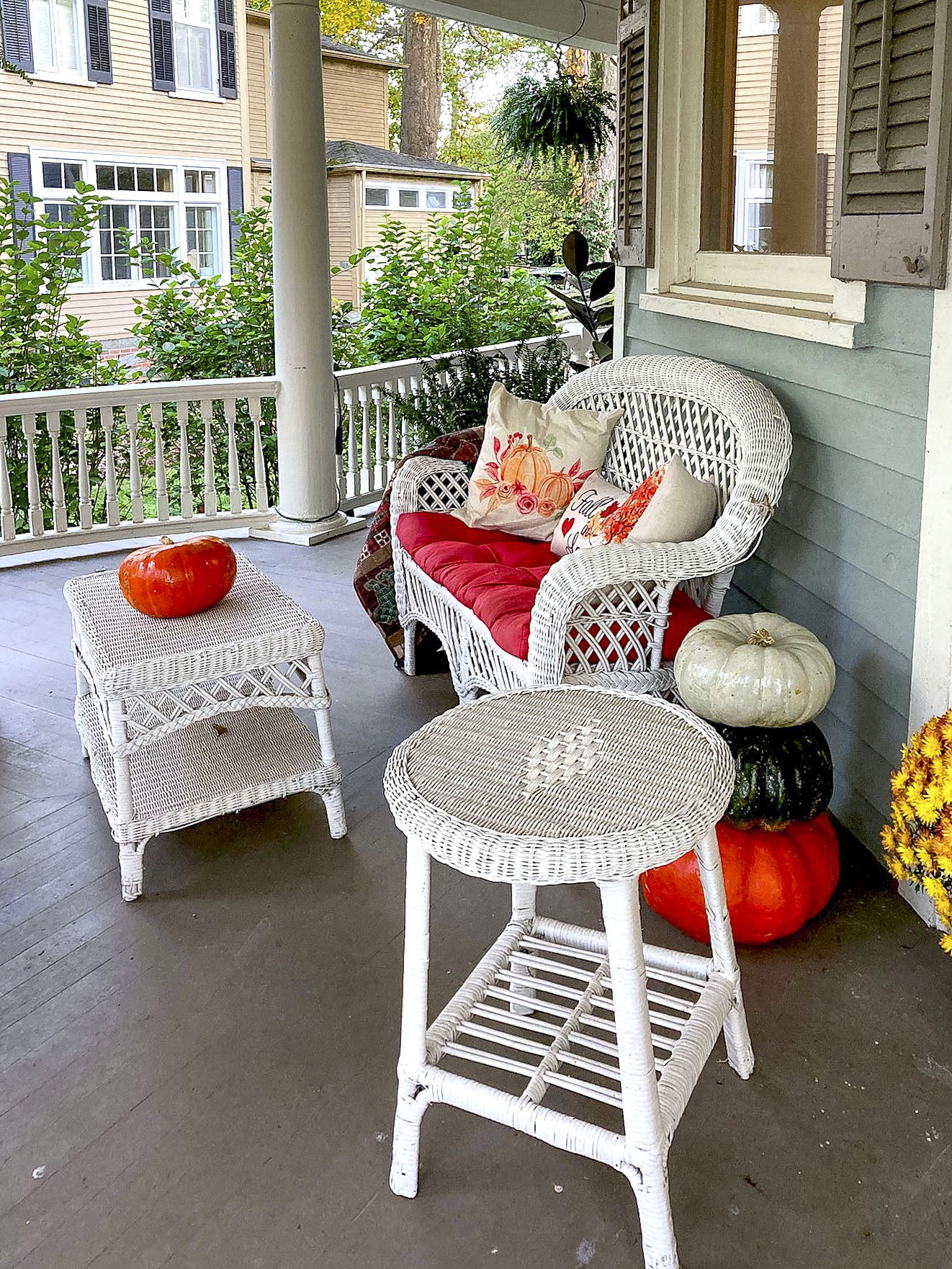 wicker seating on wrap around porch invite guests to relax