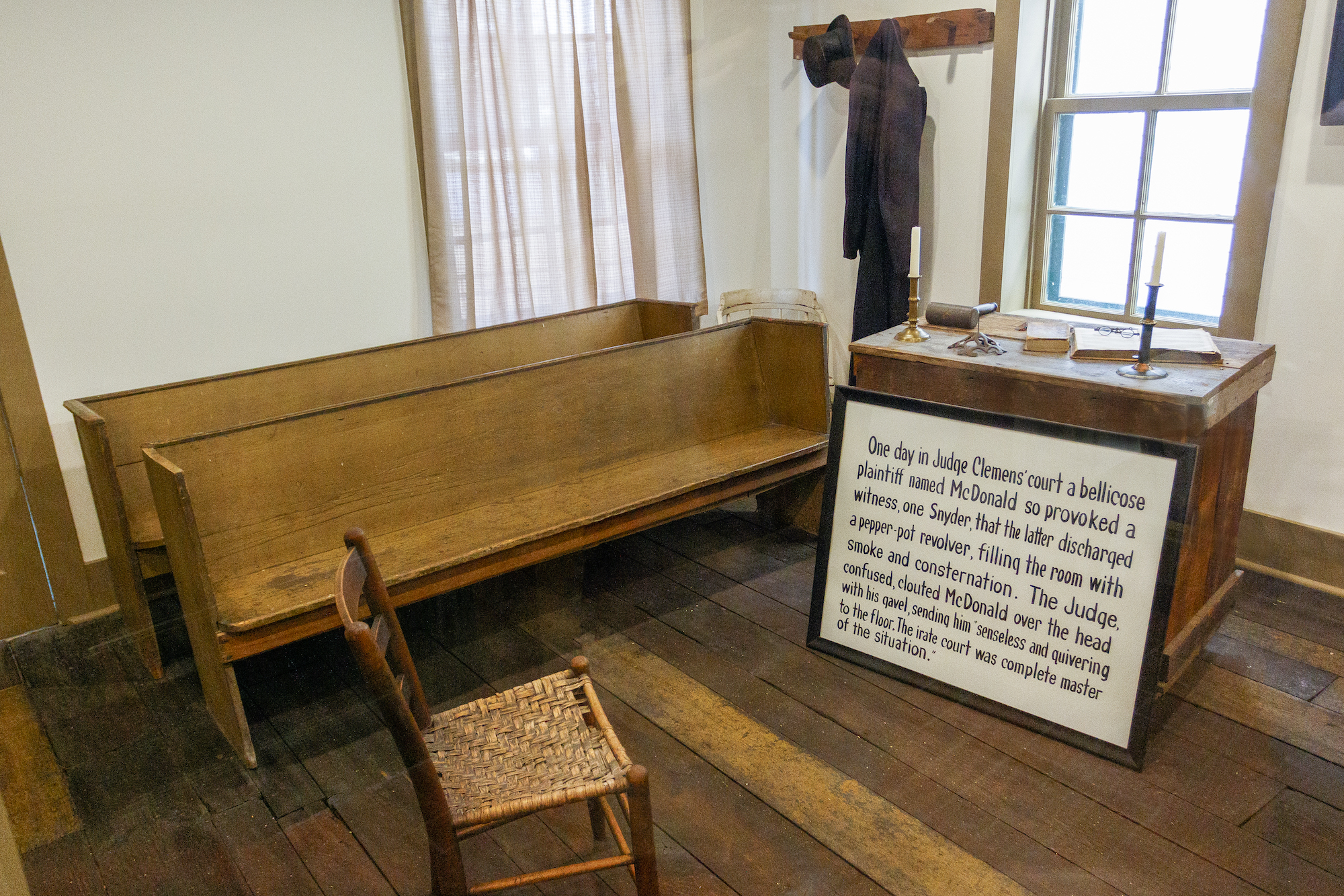 wood furniture and sign inside old courtroom