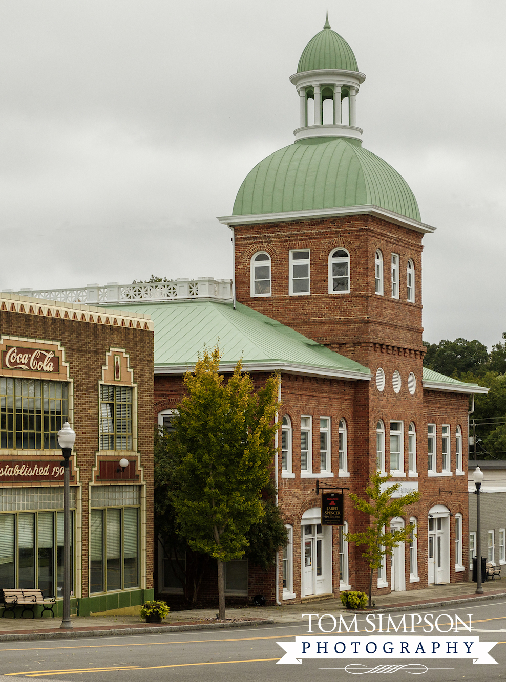 red brick building with green domed roof