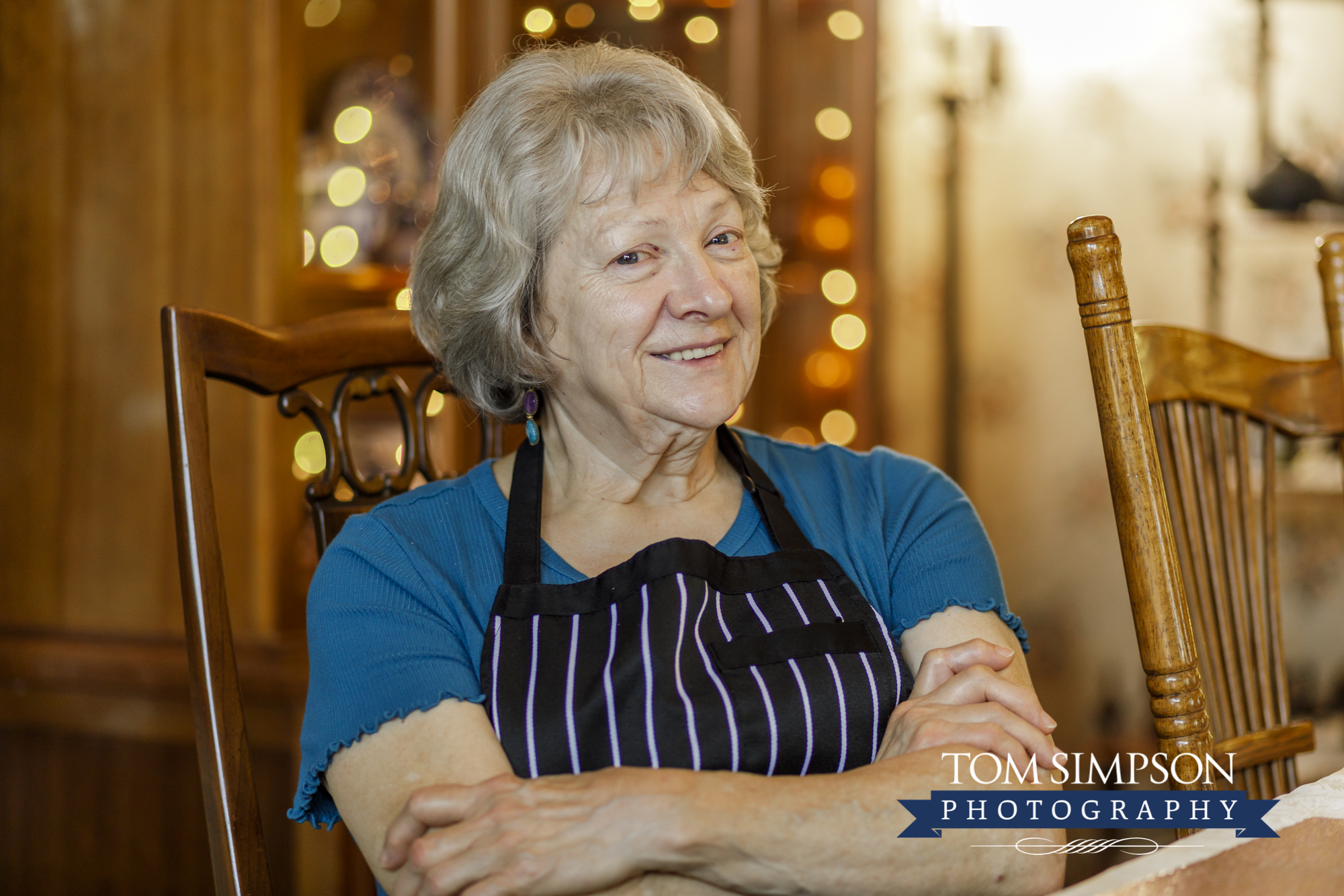 woman smiling in blue shirt and apron