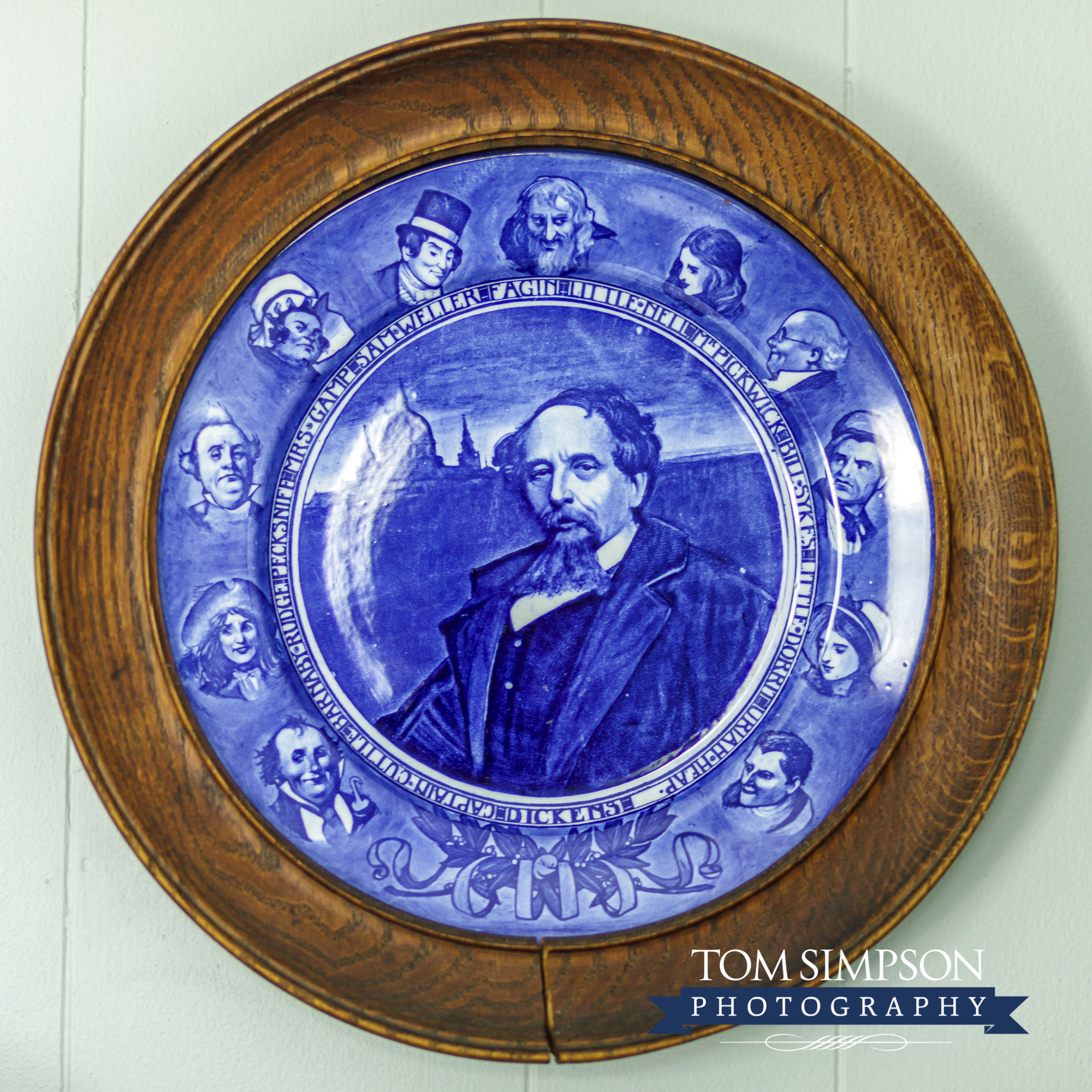 blue plate in wood frame mounted on wall