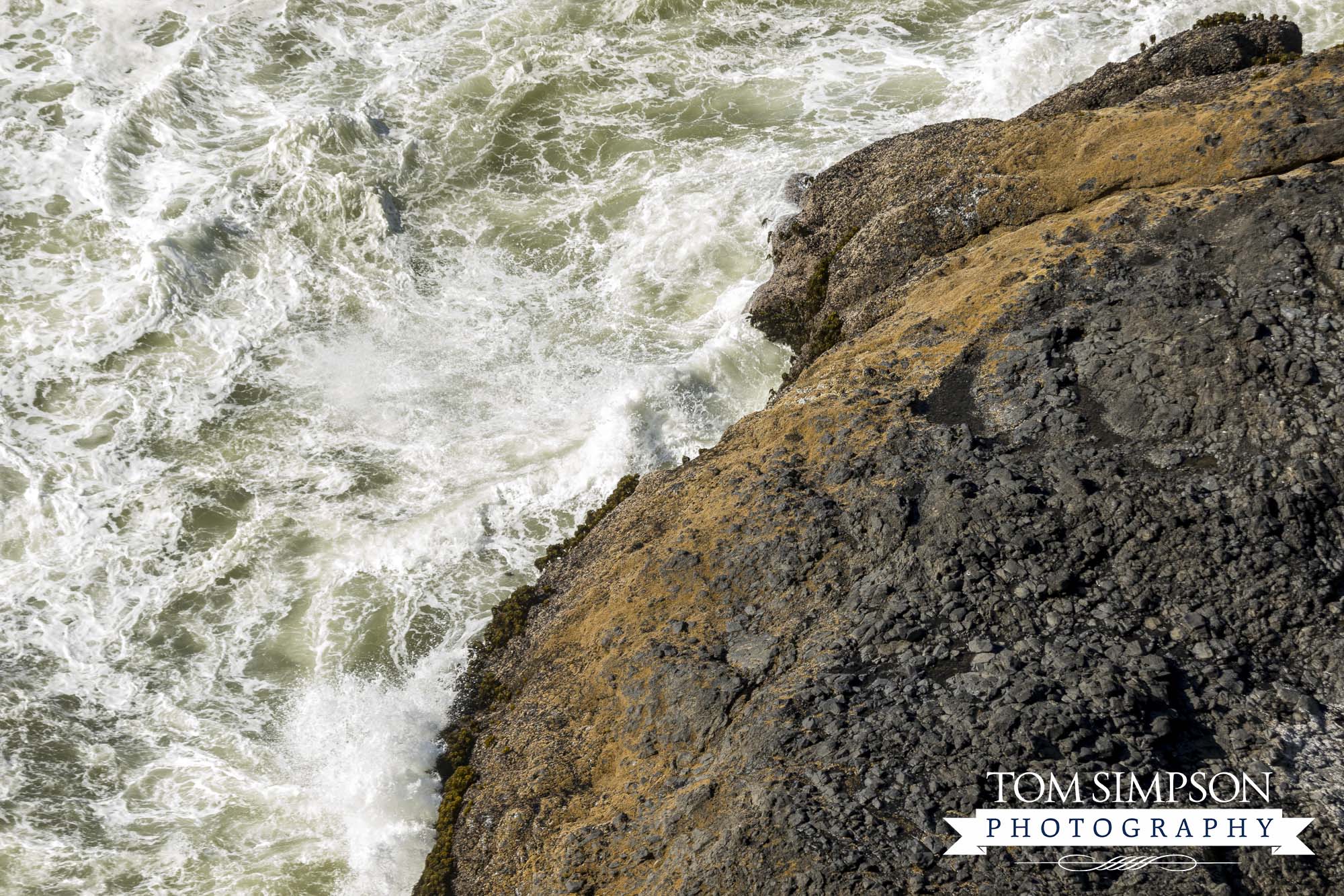 beautiful scenic viewpoint shows waves splashing on rocks